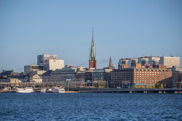 Fototapeta premium Down town with offices, church and steam boat harbor, a sunny colorful autumn day in Stockholm