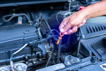 Check the oil level in car engine. Mechanic checking car engine or vehicle. Check and maintenance car with yourself.