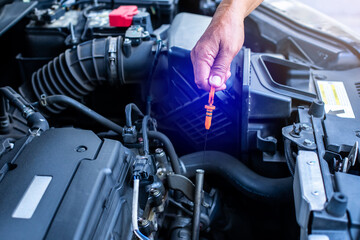 Check the oil level in car engine. Mechanic checking car engine or vehicle. Check and maintenance car with yourself.