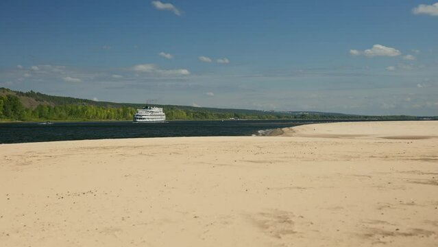 River landscape of nature in central Europe. A cruise ship goes along the river, beautiful light sand on the shore.