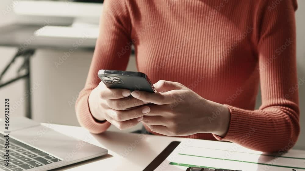 Poster a female employee is typing a message using a smartphone app to communicate with customers who place