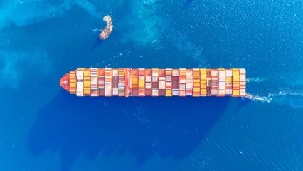  Top view Container ship full capacity approaching the port by A tugboat is pulling  International Container ship loading, unloading at sea port, Transportation, Shipping, Logistics, import export © boygek