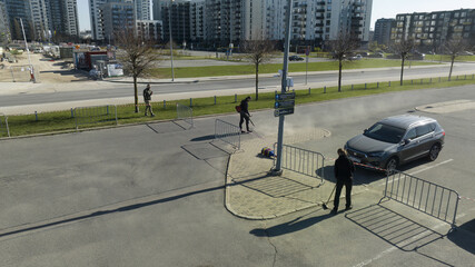 Riga, Latvia - AUGUST 20 2023.  a car parked on the side of a road next to a fence.