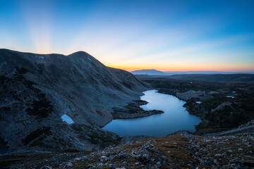 Alpine lake and sun beams in snowy range