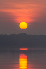 Beautiful view to the sun rising above the water in Anavilhanas
