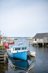 Fototapeta na wymiar Fishing Boats at dock in iconic Peggy's Cove of Nova Scotia