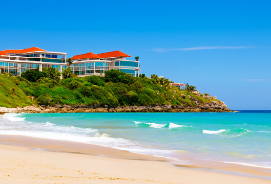 Beach scene with a luxury resort in the background. Picturesque sea landscape. Building hotel house.