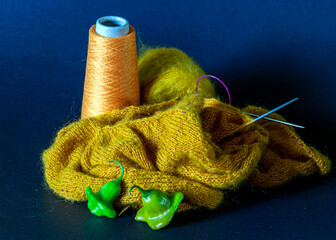 Knitted work in progress, cozy atmosphere, women's hobby knitting, the beginning of the process of...