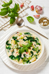 chicken spinach artichoke creamy soup in a bowl