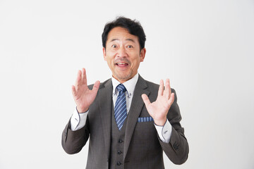 笑顔で驚く中年のビジネスマン　白背景