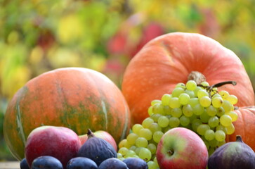 Assortment of fruits, grapes and nuts. Autumn seasonal harvest. pumpkin apples, red, yellow leaves. food still life with season fruits. Thanksgiving day, Halloween decoration fall design