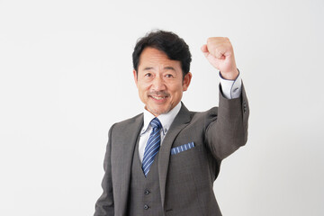 ガッツポーズをする中年のビジネスマン　白背景