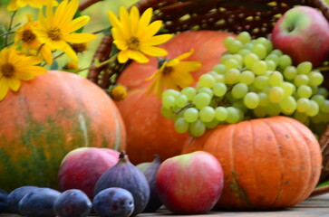 Naklejka na ściany i meble Assortment of fruits, grapes and nuts. Autumn seasonal harvest. pumpkin apples, red, yellow leaves. food still life with season fruits. Thanksgiving day, Halloween decoration fall design