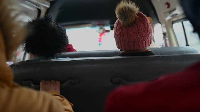 Rear view of people seated in taxi