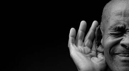 deaf man suffering from deafness and hearing loss on grey background with people stock photo	