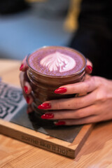 cocoa in a glass in the hands of a girl, bright nails