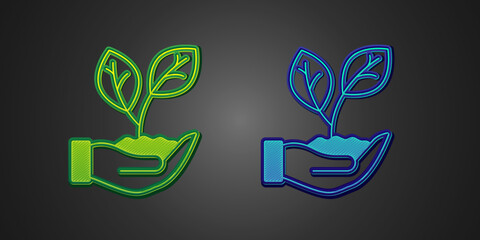 Green and blue Hand hold a leaf of the plant icon isolated on black background. Care nature. Leaf shoots with environmental protection. Vector