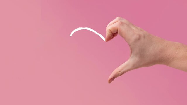A pink animated heart symbol appears near a hand and vanishes after a short duration, featured against a pink background. a collection of animated Valentine's Day cards.  Animated pink neon symbol