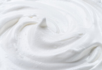 Creamy pic and waves in yoghurt or cream surface. Top view.
