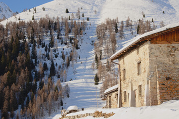 Snow covered farmhouse in the Italian Alps
