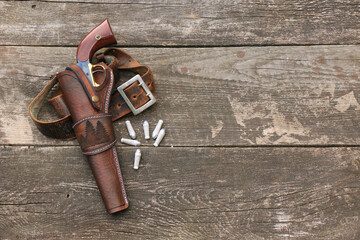 Black powder revolver in a leather holster with a leather belt and paper cartridges on the...