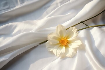 A flower with white petals and yellow center lying on a bed sheet. Generative AI