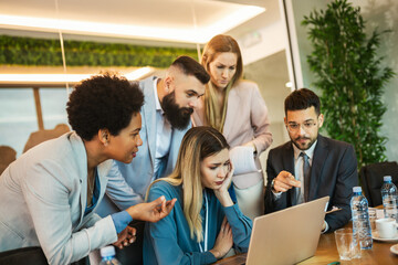 Fototapeta premium Team brainstorming. Group of business people working together on a laptop
