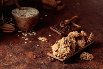 Oatmeal raisin cookies on a brown table.