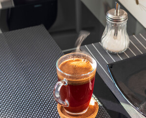 Shot of the hot coffee in the transparent cup. Beverage