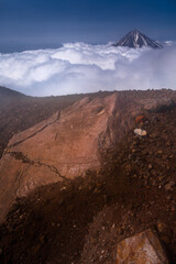 Kamchatka volcanic landscape: view to top of cone of Koryaksky Volcano from scenery active crater of Avacha Volcano on sunny day and blue sky. Russian Far East