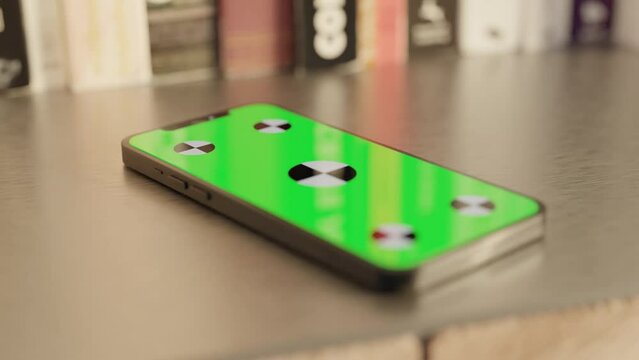 Smartphone with a Green Screen on the table