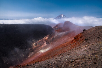 Kamchatka volcanic landscape: view to top of cone of Koryaksky Volcano from scenery active crater of Avacha Volcano on sunny day and blue sky. Russian Far East