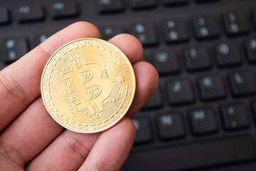 Closeup of bitcoin in hand, crypto investment concept