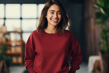 Young blond woman wearing blank red crimson sweatshirt stands in front of camera. Fashion mockup with copy space. Sweatshirt template. Generative AI