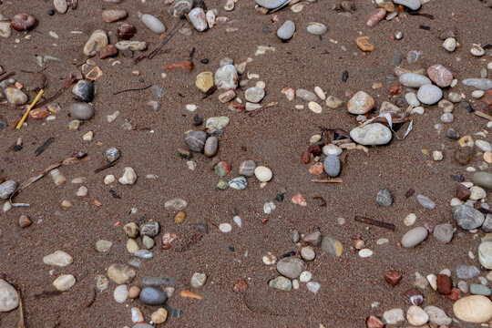 Abstract background beach sand with pebble rocks on the ground at Paralia Ixia beach off Rhodes city