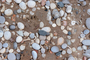 Abstract background beach sand with pebble rocks on the ground at Paralia Ixia beach off Rhodes city