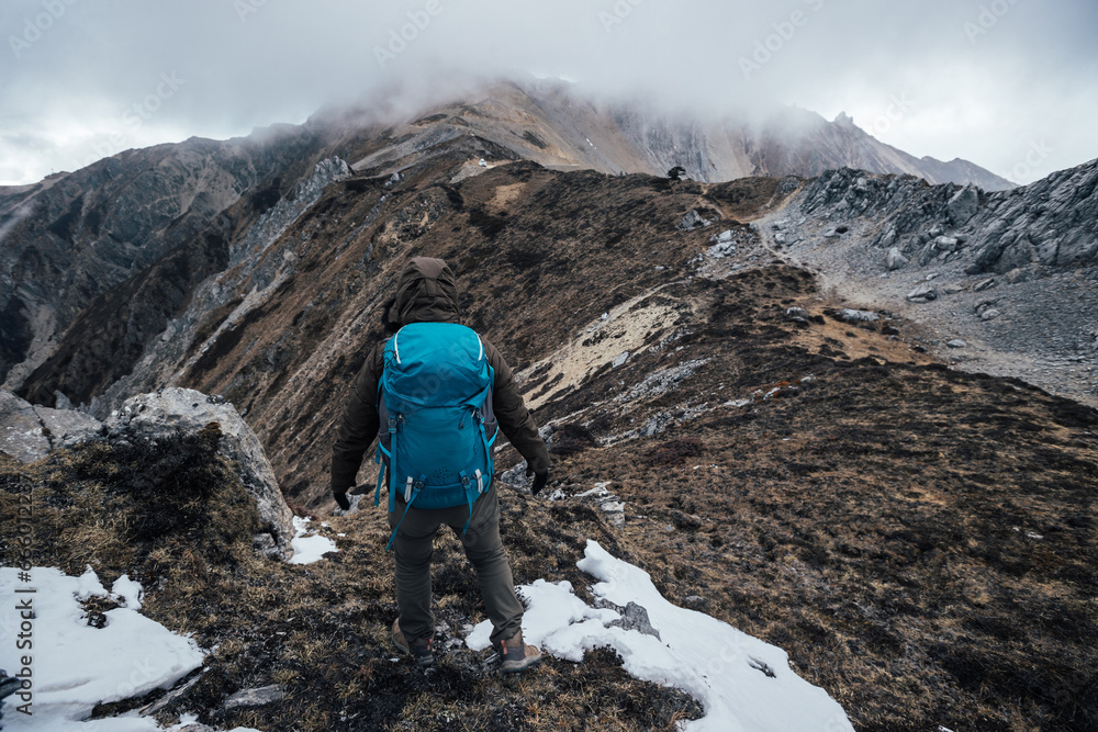 Wall mural Woman hiker hiking at mountain top in tibet