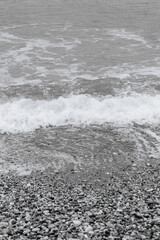 Obraz premium Clear water washing up on the shore at Paralia Ixia beach off Rhodes city in black and white