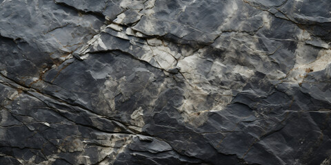 Gray rock formation texture background filled with cracks and crevices.