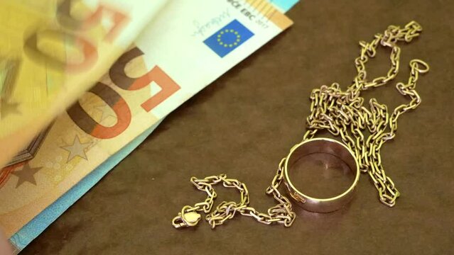 many golden jewerly and money stack, pawnshop concept, jewerly shop concept