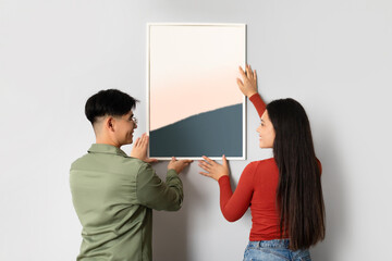 Chinese Spouses Decorating Their Living Room Wall With Modern Art