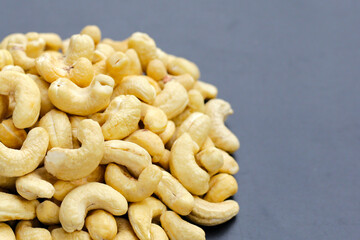 Cashew nuts on dark background.