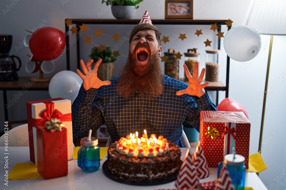 Canvas Prints caucasian man with long beard celebrating birthday holding big chocolate cake crazy and mad shouting