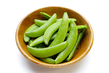 Fresh young green peas on white background.