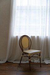 Interior photography - old chair in front of white curtains