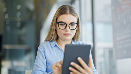 Young blonde woman business worker using touchpad at office