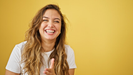 Young beautiful hispanic woman laughing a lot standing over isolated yellow background