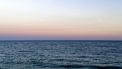 Sea and sky horizon, calm water and evening light