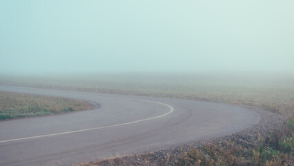 The curve of the road in the fog, pastel colors