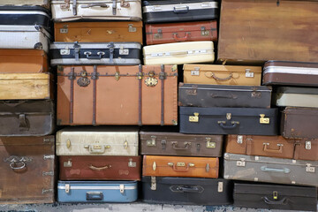 Stack of colorful vintage suitcases. Retro decorative suitcases, new vacation plans and journeys. old style suitcases stacked on top of each other